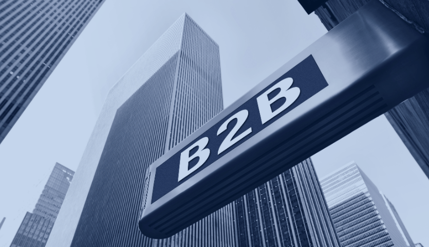 Prédios e uma placa com a descrição B2B, represntando o mercado B2B.
